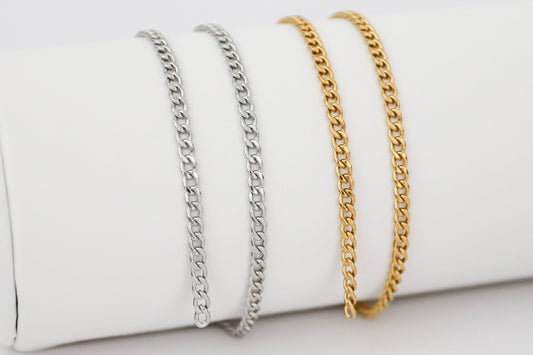 two bracelets (gold and silver) hanging side by side